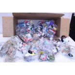 A box full of assorted Mc Donald's toys mainly Snoopy
