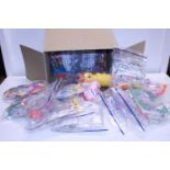 A box full of various McDonald's collectors toy sets for the New Zealand market