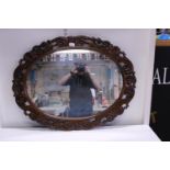 A large vintage hand carved wooden framed mirror 90cm by 70cm. Shipping unavailable