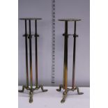 A pair of early 20th century brass adjustable shop display stands 50cm tall at lowest extension