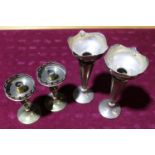 A pair of silver plated bud vases & a pair of Arts & Crafts style candle sticks