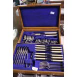 A vintage cased set of cutlery presented in an oak box
