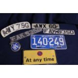 A selection of assorted vintage registration plates & other items