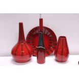 A selection of red glazed ceramic items. Postage unavailable