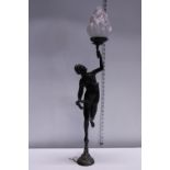 A heavy bronze sculpture of a woman holding a flame. In the form of a lamp. Was attached to a