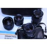 A Praktica B200 camera with a selection of assorted lenses
