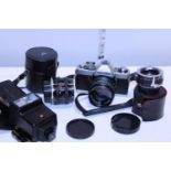 A vintage Minolta XG1 camera & selection of lenses