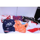 A selection of assorted sport shirts, assorted children's and adults sizes