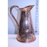 A antique arts and craft period copper jug made in Belday