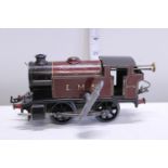 A vintage tin plate O gauge clockwork locomotive