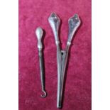 A pair of silver handled glove stretcher's and a silver handled button hook