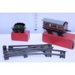 Two boxed O gauge tin plate models and O gauge track
