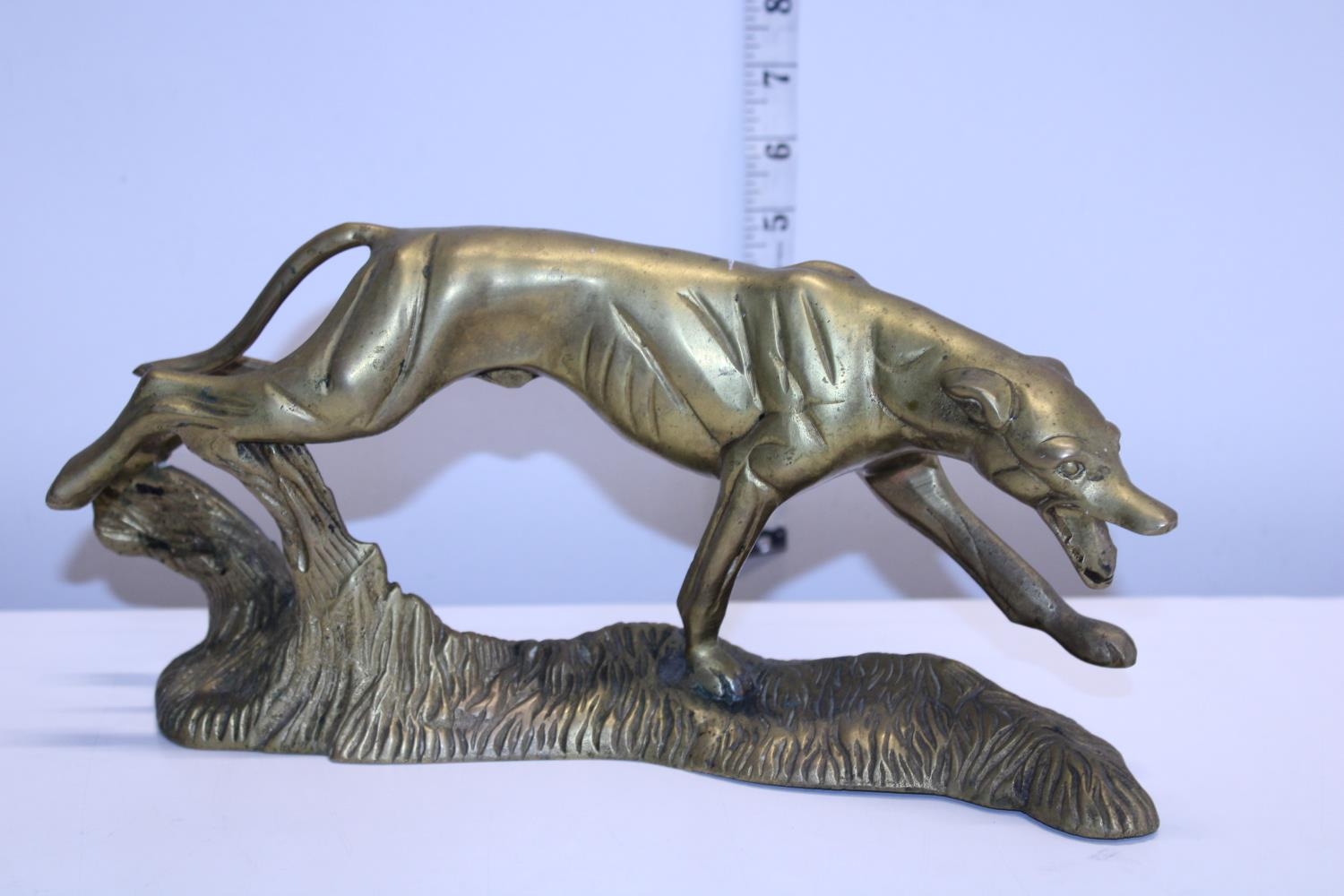 A heavy brass figure of a hunting dog w30cm