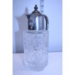 A silver plated small cut glass claret jug