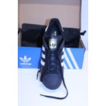 A new pair of Adidas Superstar training shoes size 8