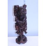 A hand carved Oriental wooden figure