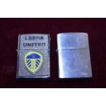 A zippo lighter and a Leeds united Zippo style lighter