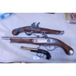 Three decorative hanging flintlocks