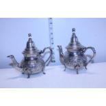 Two well decorated small silver plated middle eastern coffee pots