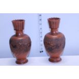 A pair of Chinese terracotta style vases with dragon decoration