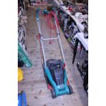 A Bosch electric lawn mower (unchecked), shipping unavailable