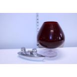 A large red glass brandy balloon and a novelty ship form condiment set