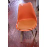 A mid-century style orange chair, shipping unavailable