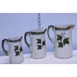 A set of three graduated jugs