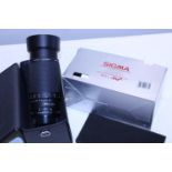 A boxed Sigma APO zoom lens