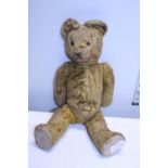 A vintage articulated plush bear.