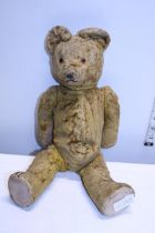 A vintage articulated plush bear.