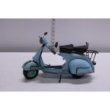 A metal model of a Vespa scooter