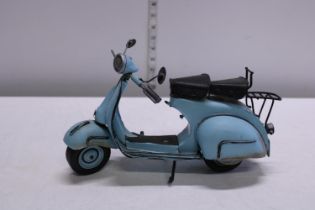 A metal model of a Vespa scooter