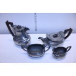 A high quality hand hammered pewter tea and coffee set with Bakelite handles