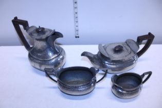 A high quality hand hammered pewter tea and coffee set with Bakelite handles