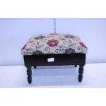 A antique upholstered footstool with storage. No postage