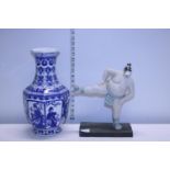 A Oriental blue and white vase and figure of a sumo wrestler