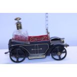 A novelty vintage musical decanter holder in the form of a car with matching decanter