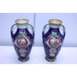 A pair of ornate Edwardian vases, one with repair to rim