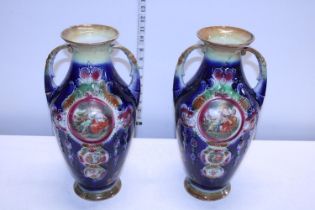 A pair of ornate Edwardian vases, one with repair to rim