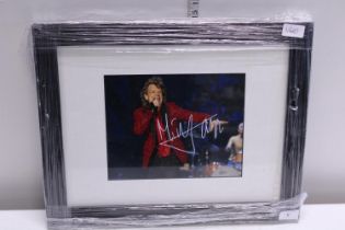 A signed photo of Mick Jagger with certs of authenticity.