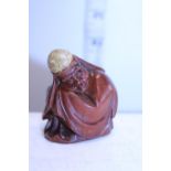 A Oriental carved wooden figure