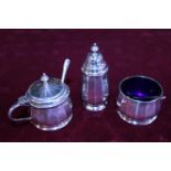 A hallmarked silver condiment set complete with blue liners