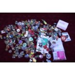 A large selection of assorted enamel badges