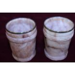 A pair of carved stone beakers