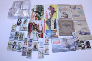 A job lot of assorted cigarette card albums and cards