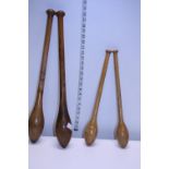 Two pairs of early 20th century wooden keep fit batons