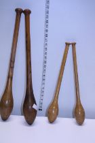 Two pairs of early 20th century wooden keep fit batons