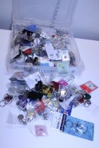A large quantity of new keyrings and badges etc