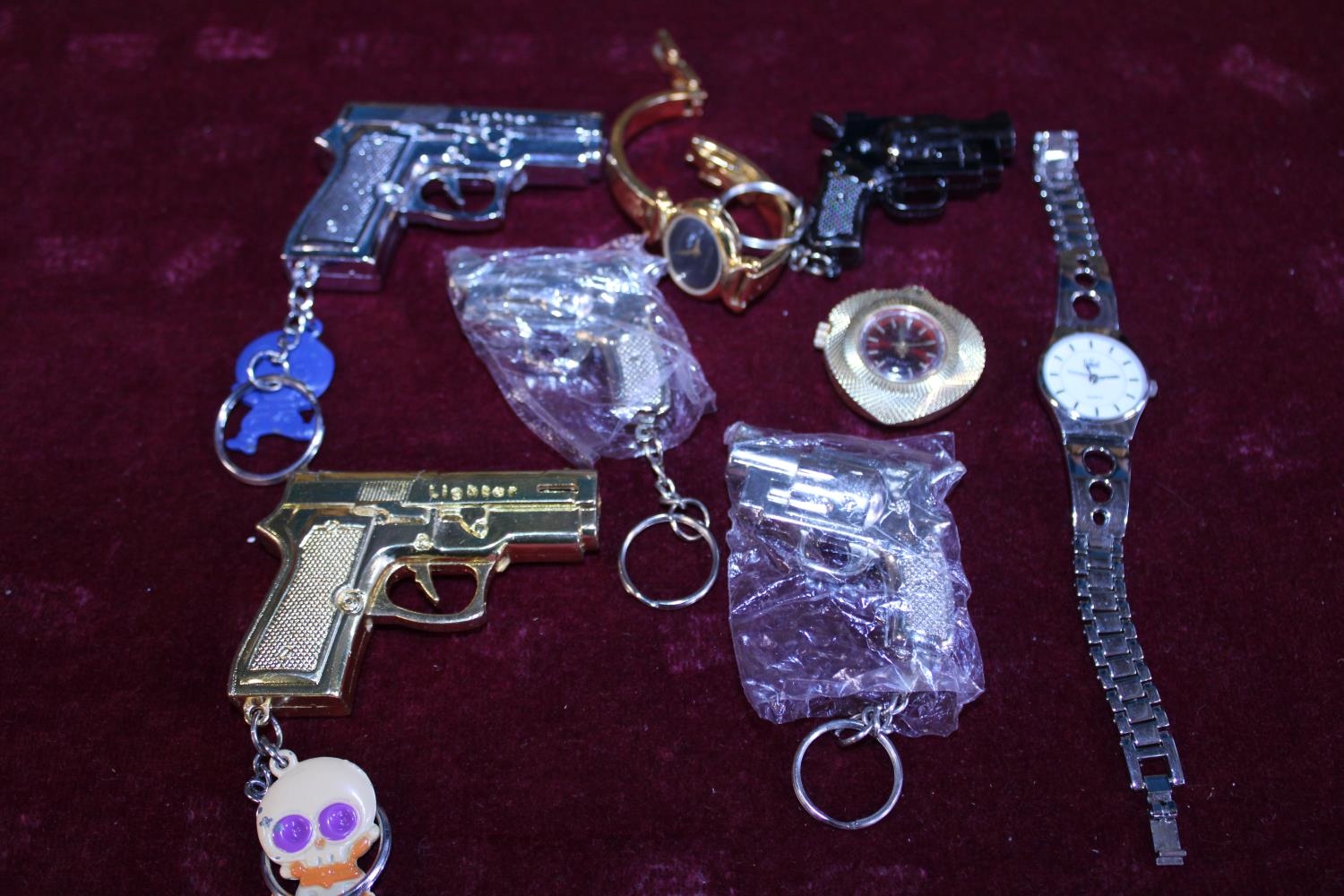 A selection of novelty lighters and assorted watches